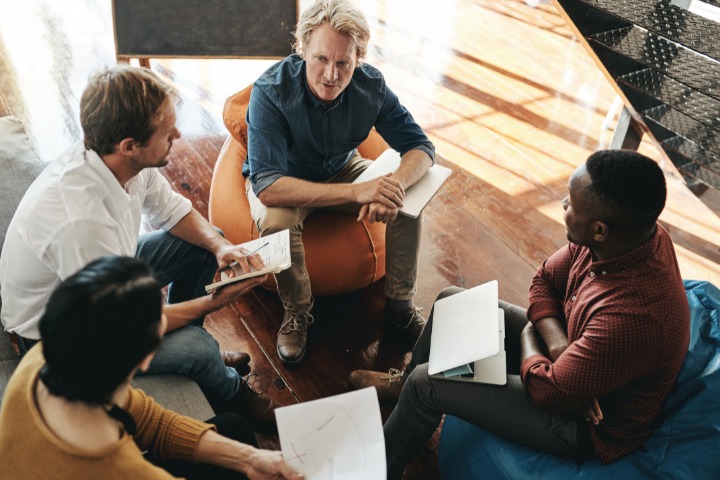 group of marketers engaged in a brand strategy discussion