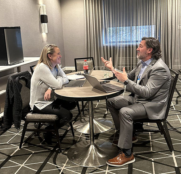 Marketing consultant from NextLevel Thinking discussing strategies with a client during a business meeting