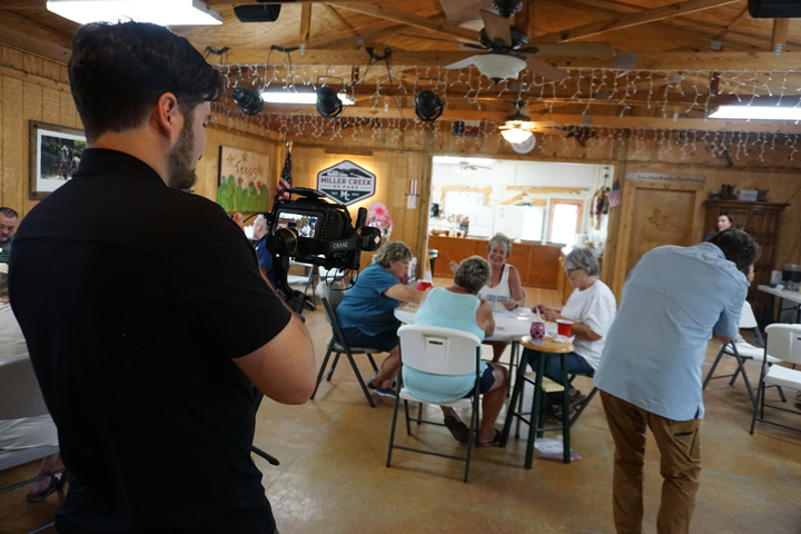 Marketing agency video production team capturing footage at Miller Creek RV Park event hall