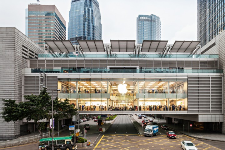Apple Store with its glass facade and iconic logo, symbolizing the brand’s global impact and transformative retail strategy