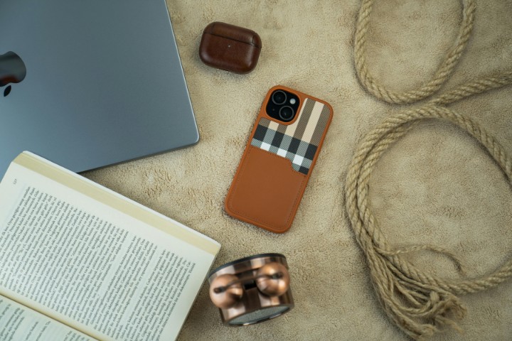 Stylish Burberry iPhone case paired with a laptop, watch, and book