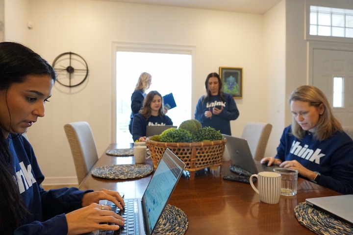 marketing professionals from NLT engaged in a brainstorming session at their Houston office