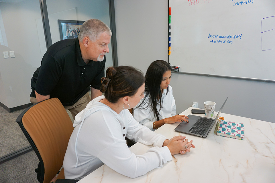 NLT brand consultants collaborating on a marketing strategy at a desk