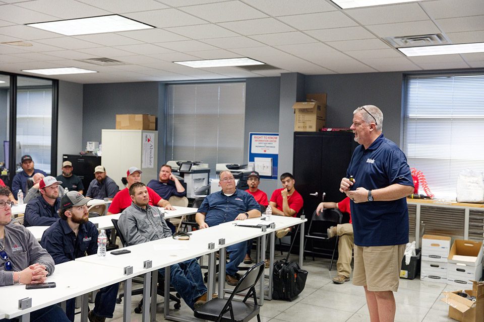 Construction industry professionals at Absolute Testing Services receiving a brand consulting workshop led by Eric from NLT